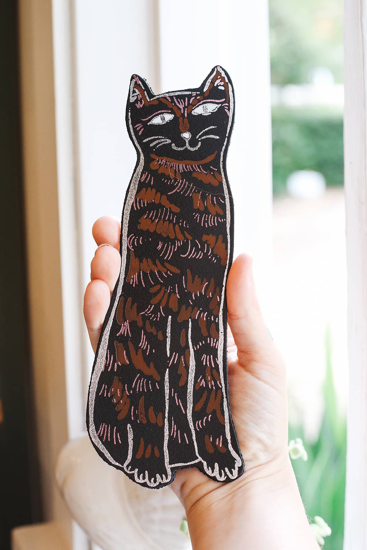 Àine & Co. Ark Bookmark in cat, featuring illustrated smiling black and brown cat