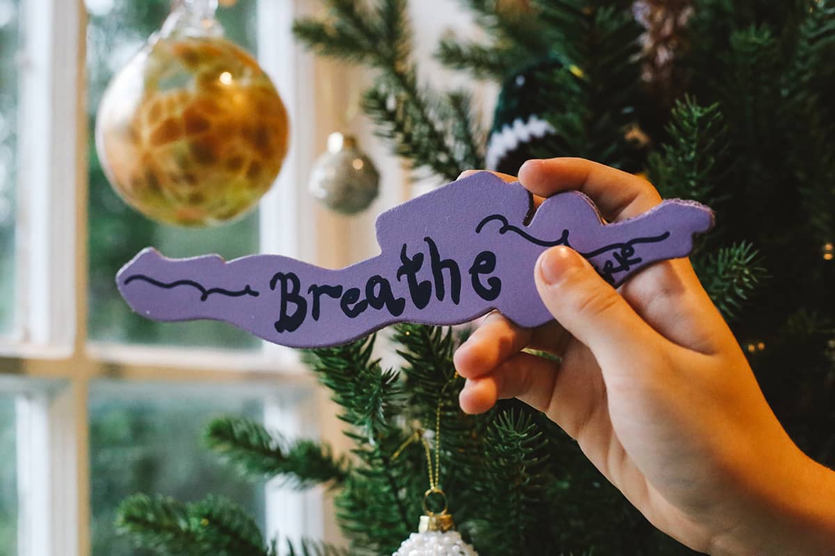Back of Àine & Co. Ark Bookmark in Scuba, purple background with graphic text "Breathe" and Ark signature