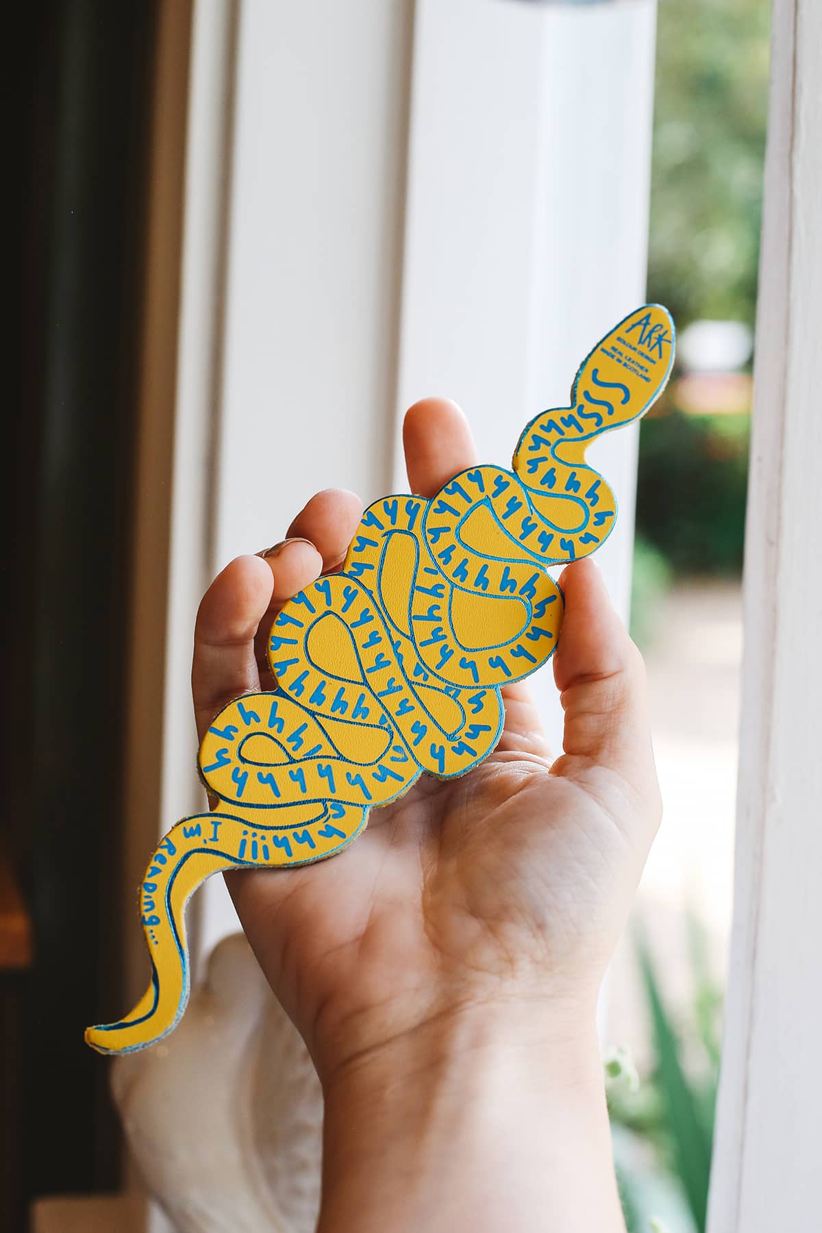 Àine & Co. Ark Bookmark in snake, featuring illustrated blue and yellow snake design with graphic text "Shhh I'm reading" and ARK signature