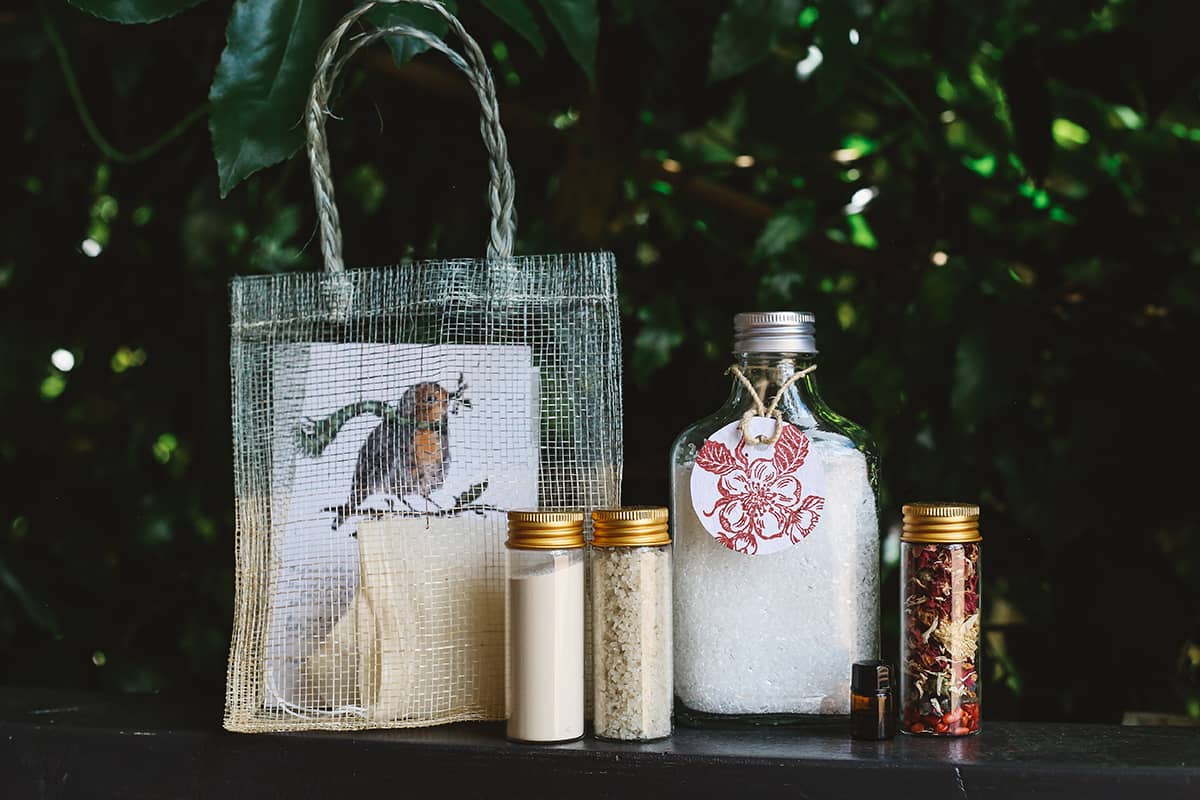 Àine & Co. Bath Salts DIY Gift Bag contents, featuring epsom salts, botanicals, clay, lavender essential oil, DIY instructions and a Sinamay bag