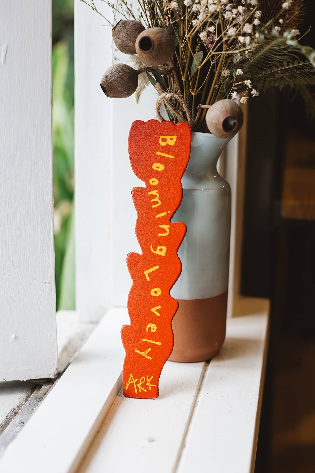 Back of Àine & Co. Ark Bookmark in multicolour abstract flower design, with text "Blooming Lovely - Ark"