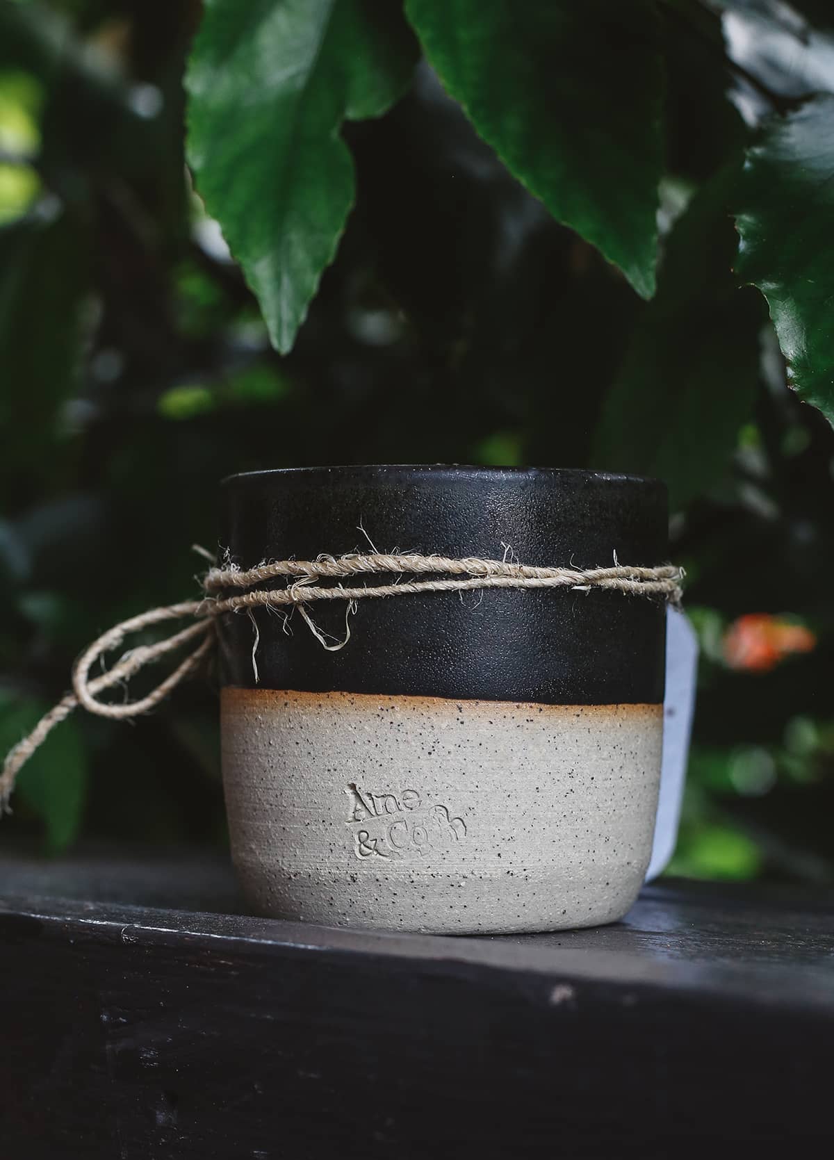 Àine & Co. Ceramic Tumbler Candle in black, featuring cylindrical ceramic cup with natural speckled white on the bottom half and black glaze on the top half