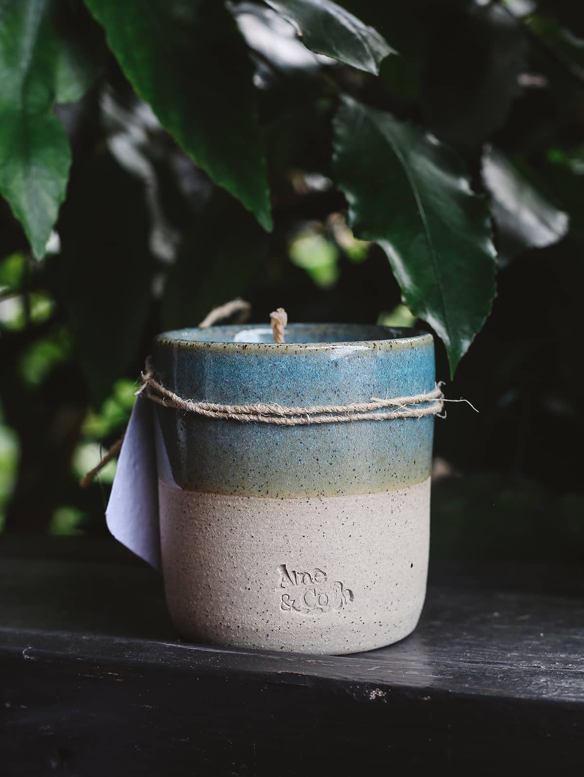 Àine & Co. Ceramic Tumbler Candle in blblueack, featuring cylindrical ceramic cup with natural speckled white on the bottom half and light blue glaze on the top half