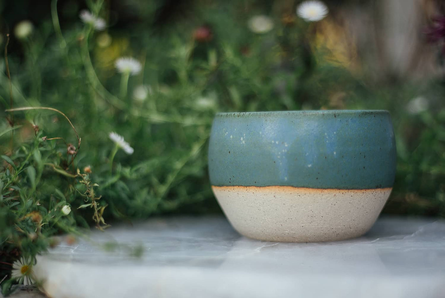 Àine & Co. Comfort Cup in Murúch (Mermaid). A reusable ceramic candle cup featuring a light teal colour.