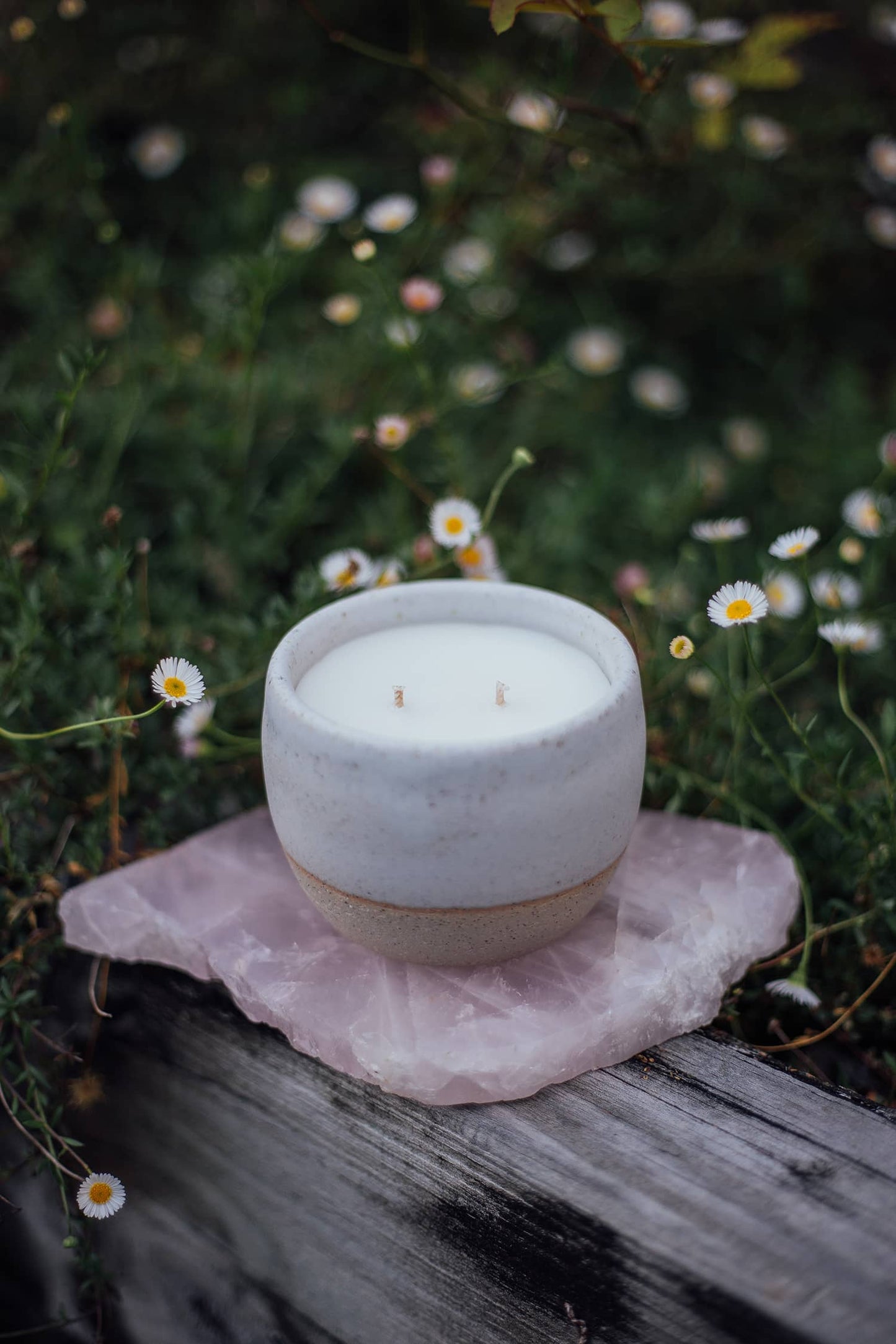 Àine & Co. Comfort Cup in Gealghrá (Tender Pure Love). A reusable ceramic candle cup featuring a speckled white colour. Filled with a candle with two wicks.