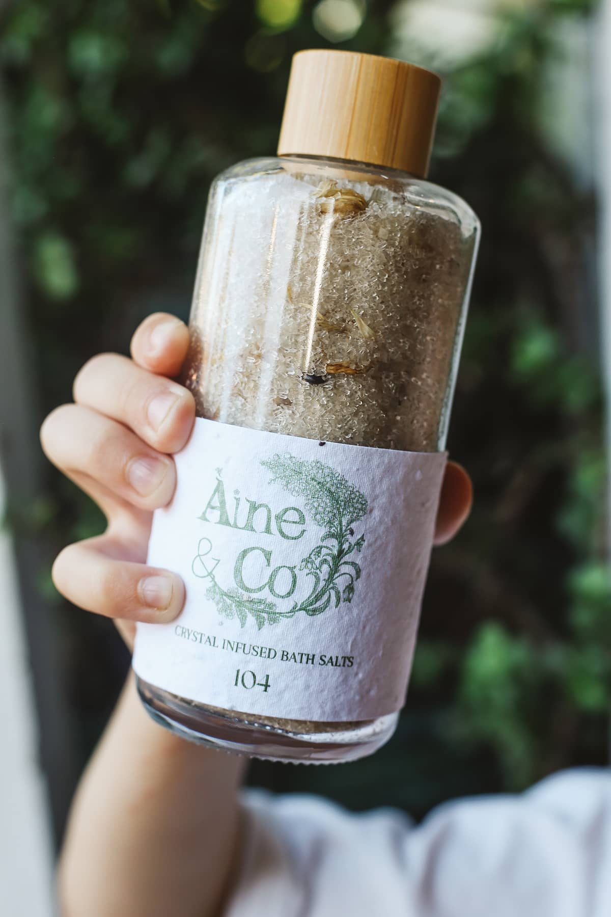Àine & Co. Crystal Infused Bath Salts in 104, packaged in glass bottle with wooden lid