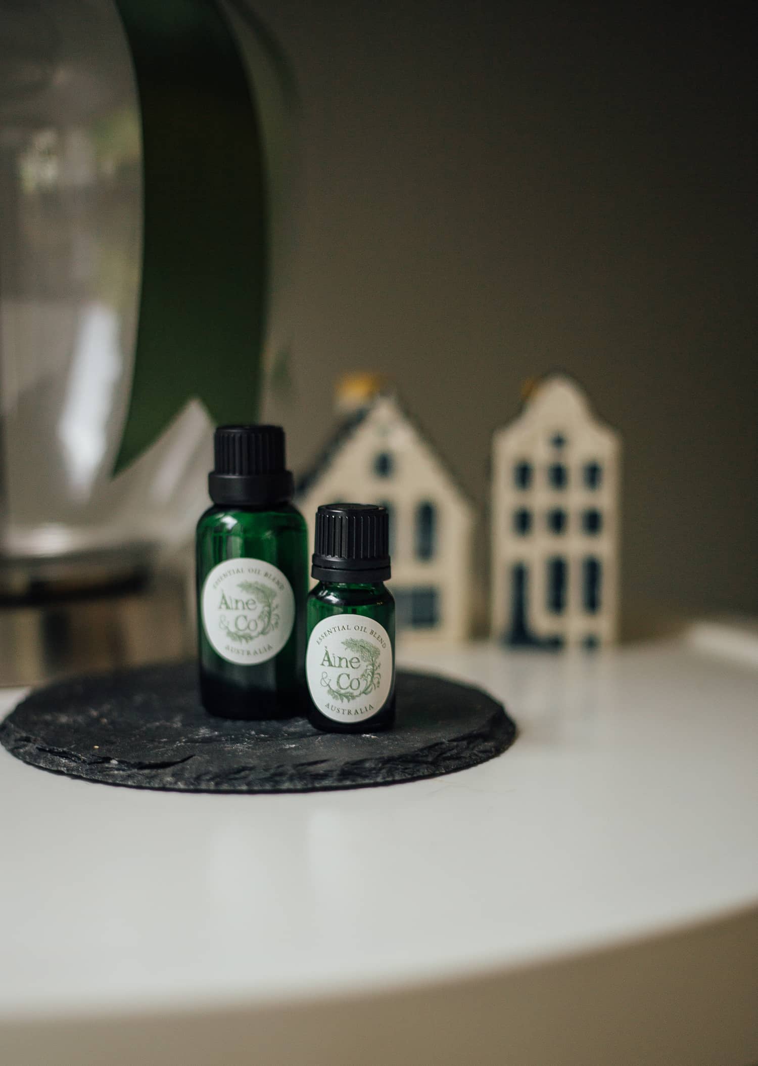 Àine & Co. Essential Oil Blend in Australia, packaged in green dropper bottles in 10ml and 30ml, styled on a coffee table