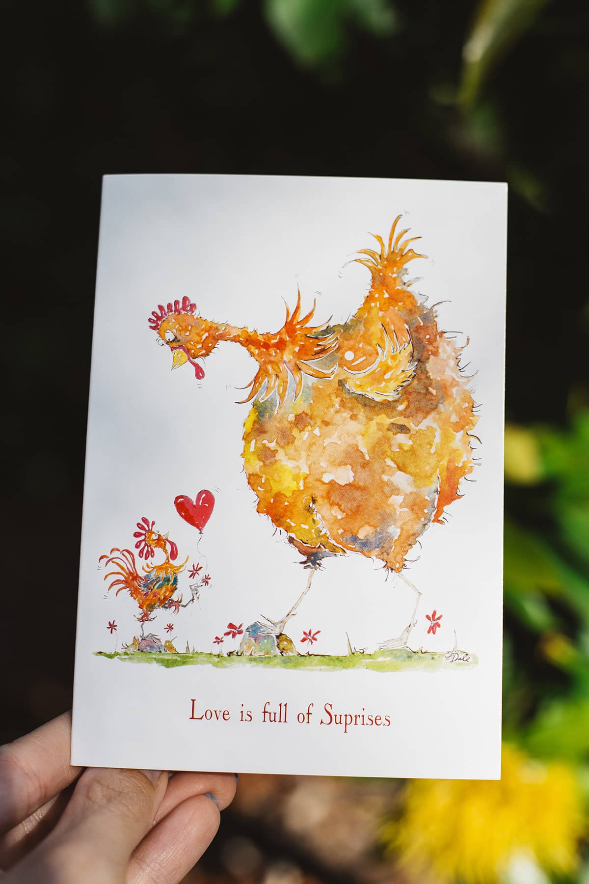 Àine & Co. gift card by Australian Artist, Heather Dale, featuring illustrated baby hen presenting love heart to mother hen, with text "Love is full of surprises"
