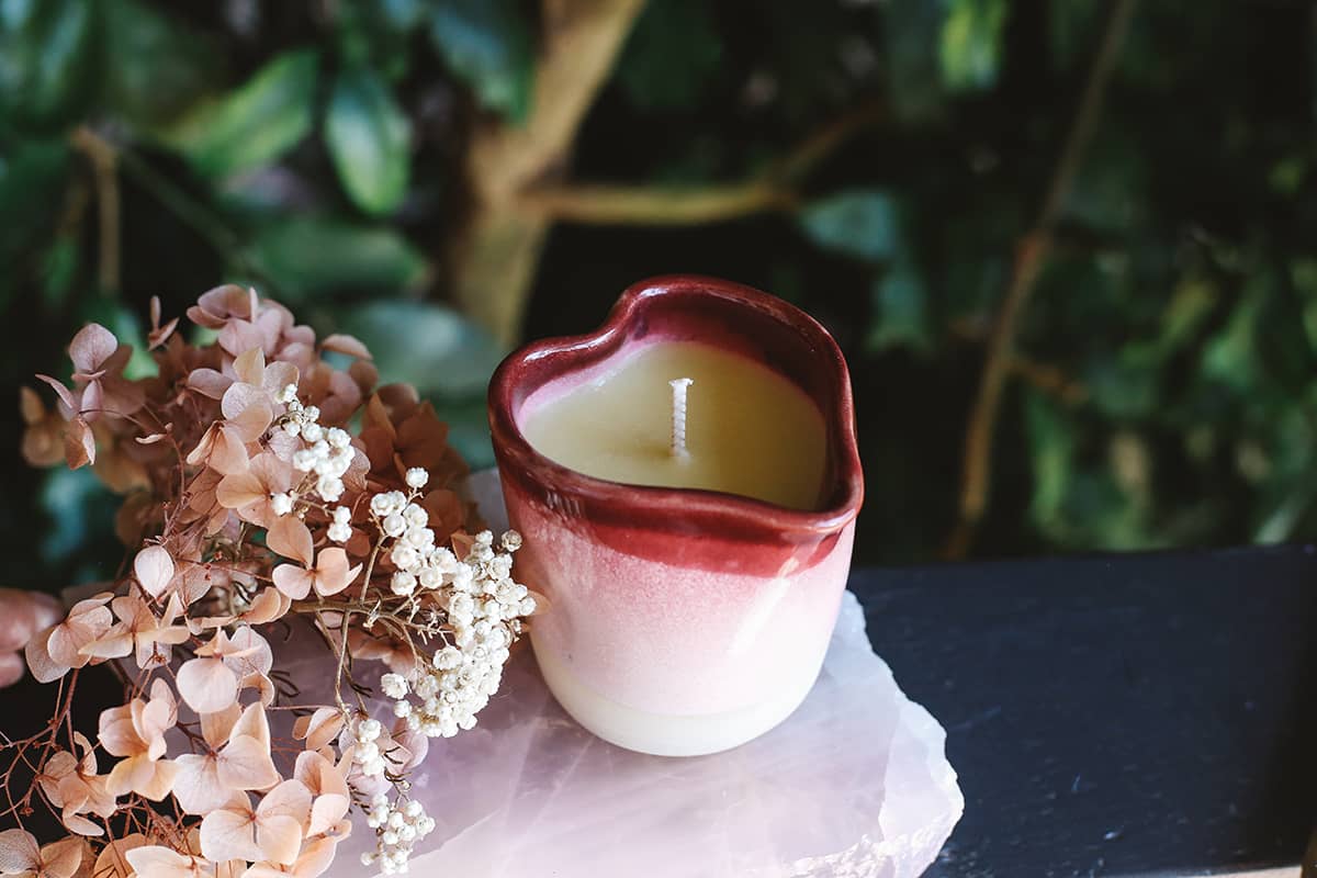 Àine & Co. Heart of Lupercalia Candle Jug featuring heart shaped ceramic jug with red and pink glaze