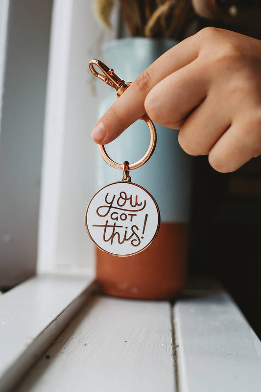 Àine & Co. Alphabet Bags metal keyring featuring circle shape with gold hardware and gold text "You Got This!" on white background