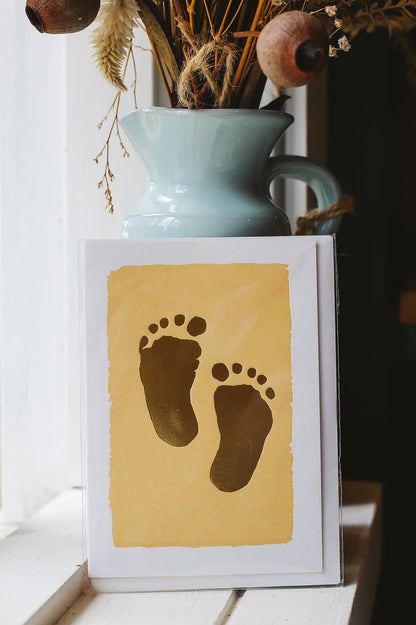 Àine & Co. Archivist greeting card featuring toddler's footprint on pastel yellow background