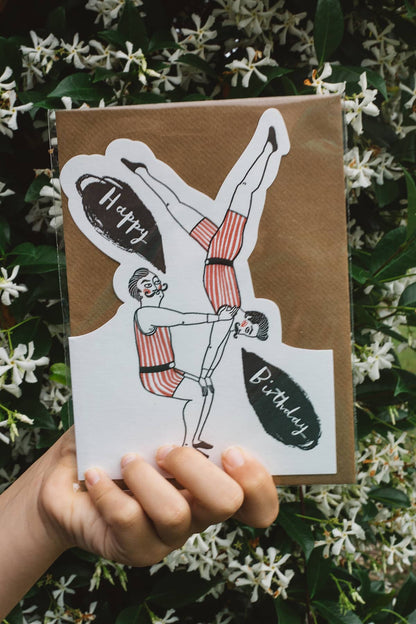 Àine & Co. Archivist greeting card featuring male gymnasts balancing on each other with text "Happy Birthday"
