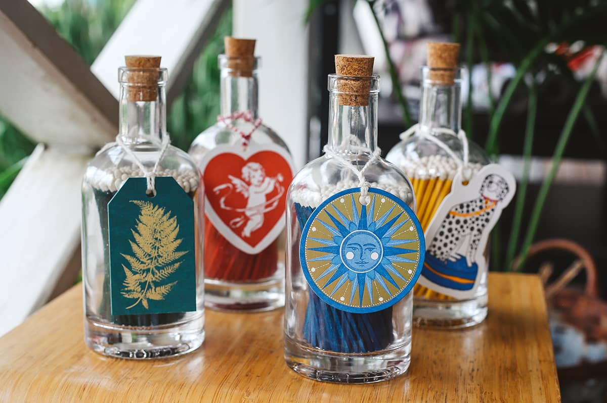 Archivist Match Bottles featuring long coloured matches in a corked glass bottle with various designed gift tags