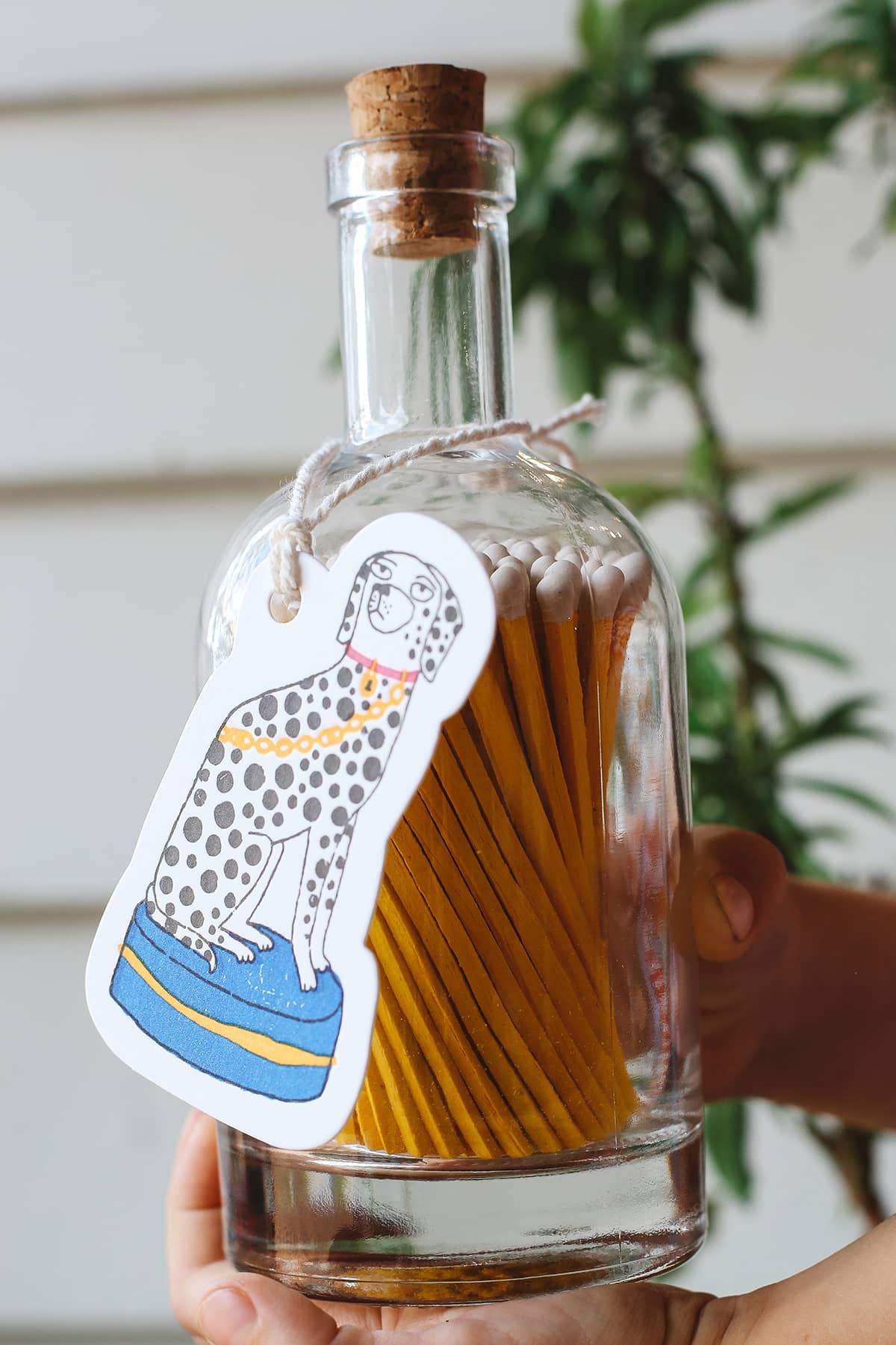 Archivist Match Bottle featuring long orange matches in a corked glass bottle with a Dalmatian gift tag