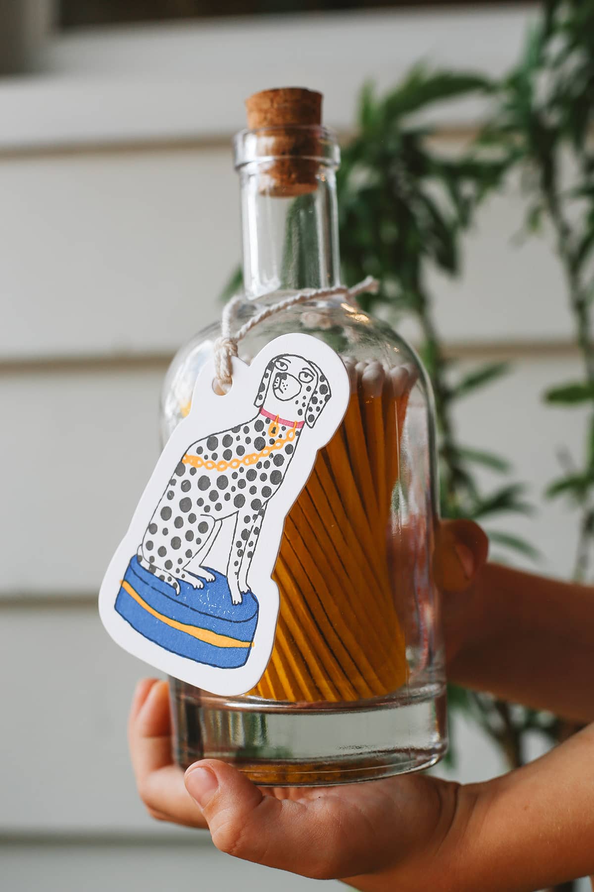 Archivist Match Bottle featuring long orange matches in a corked glass bottle with a Dalmatian gift tag