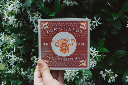Archivist Luxury Matches with red vintage design of bees and graphic text "Bee's Knees Trademark Luxury Matches"