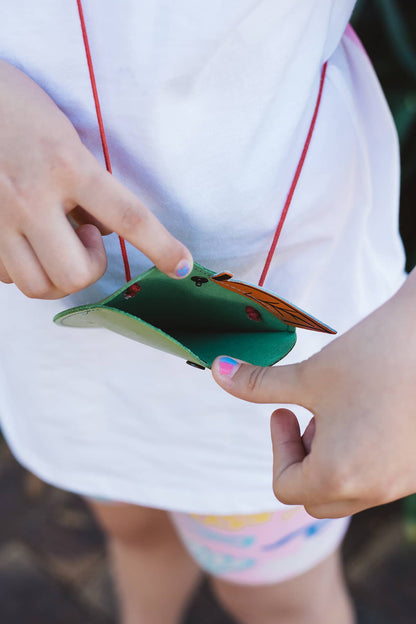 Àine & Co. Ark leather crossbody Coin Purse in Apple, featuring green apple with pink worm design and snap button closure