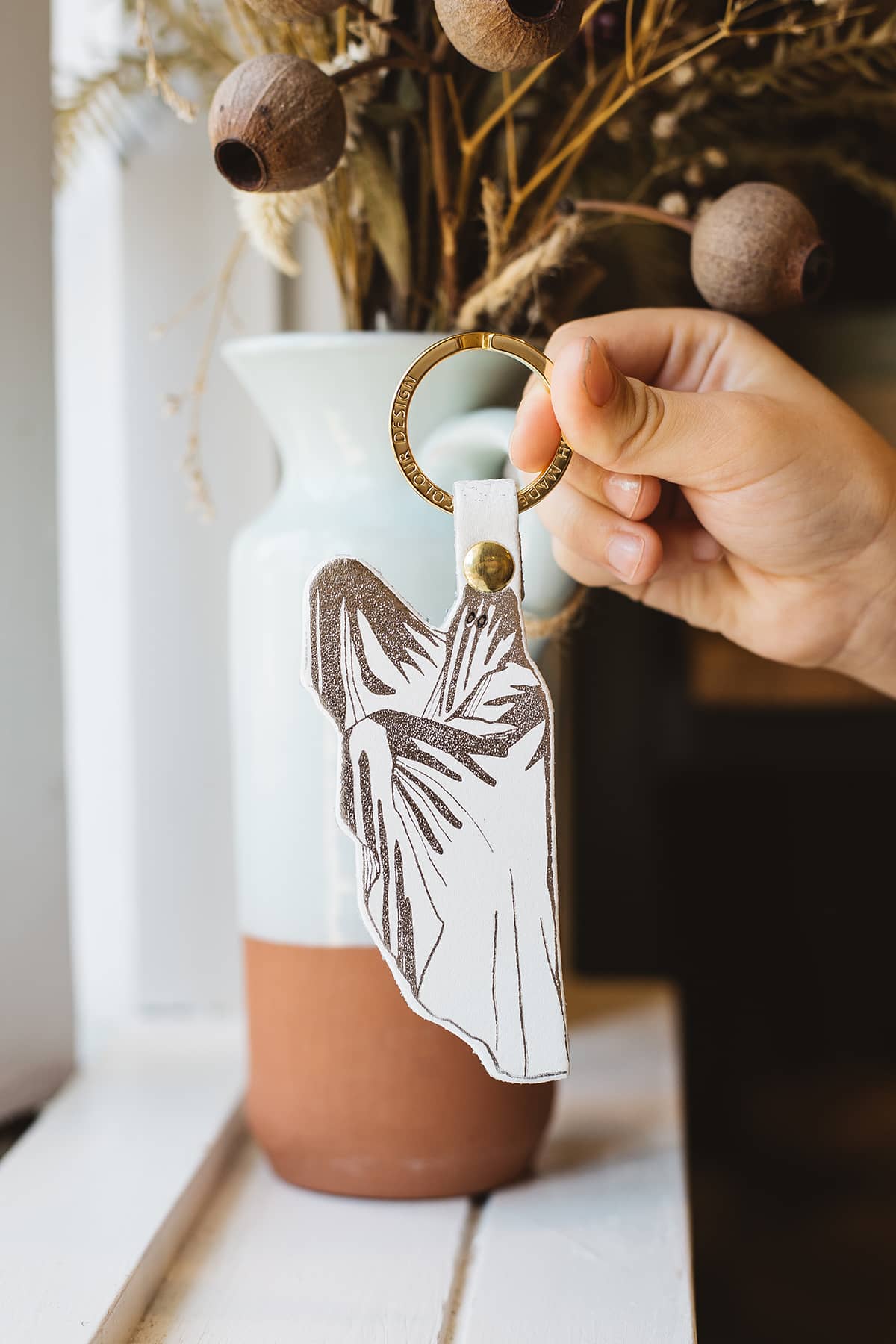 Àine & Co. Ark Leather Keyring in Spoo-Key, featuring white sheet ghost design with gold hardware