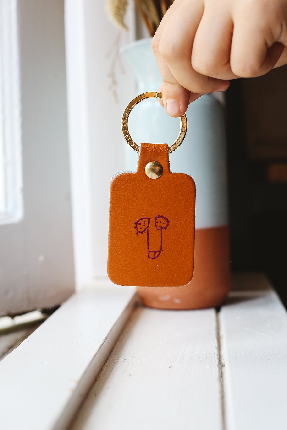 Àine & Co. Ark Colour Design Keyring in "Male (Tan)", featuring leather with illustrated penis design and gold hardware