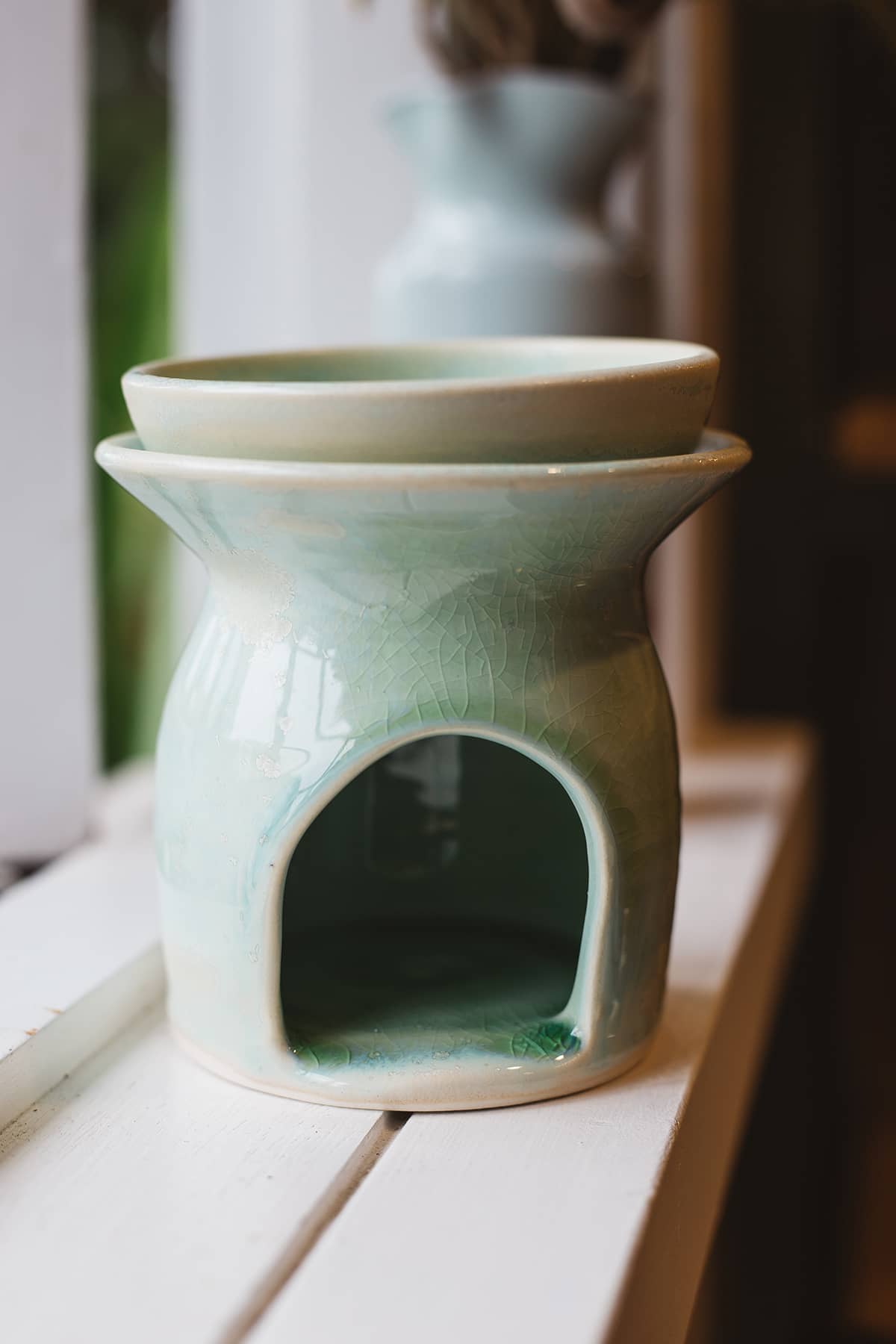 Àine & Co. Clay Temple Tea Light Burner in Green. Upper section of burner nested in lower one.