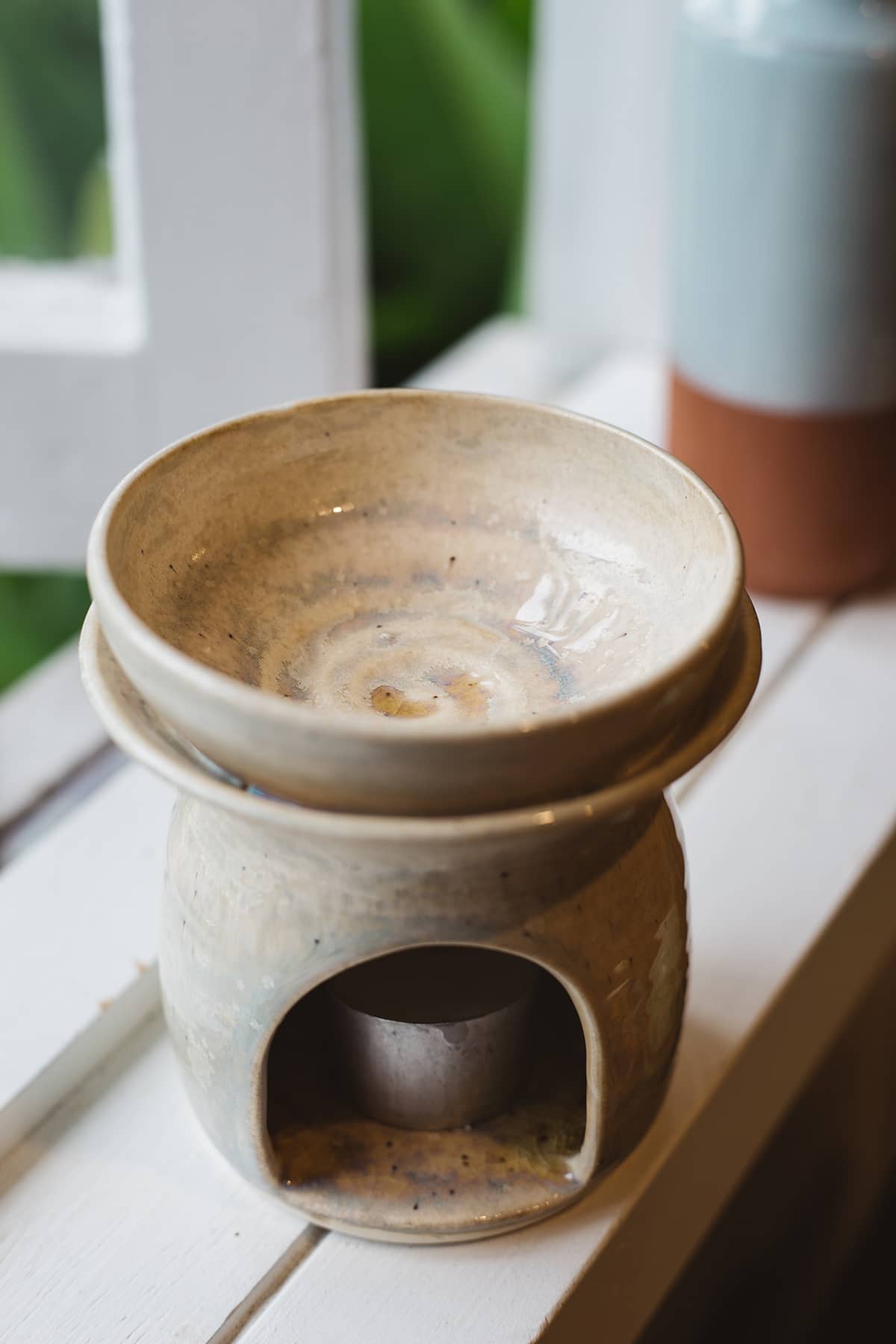 Àine & Co. Clay Temple Tea Light Burner in Natural. Upper section of burner nested in lower one, with a swirl  design in the centre.