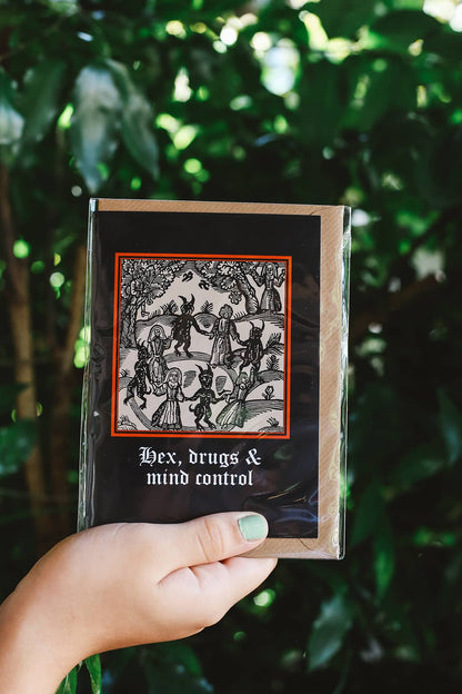 Clavis & Claustra greeting card featuring black background and illustration with graphic text "Hex, drugs and mind control"