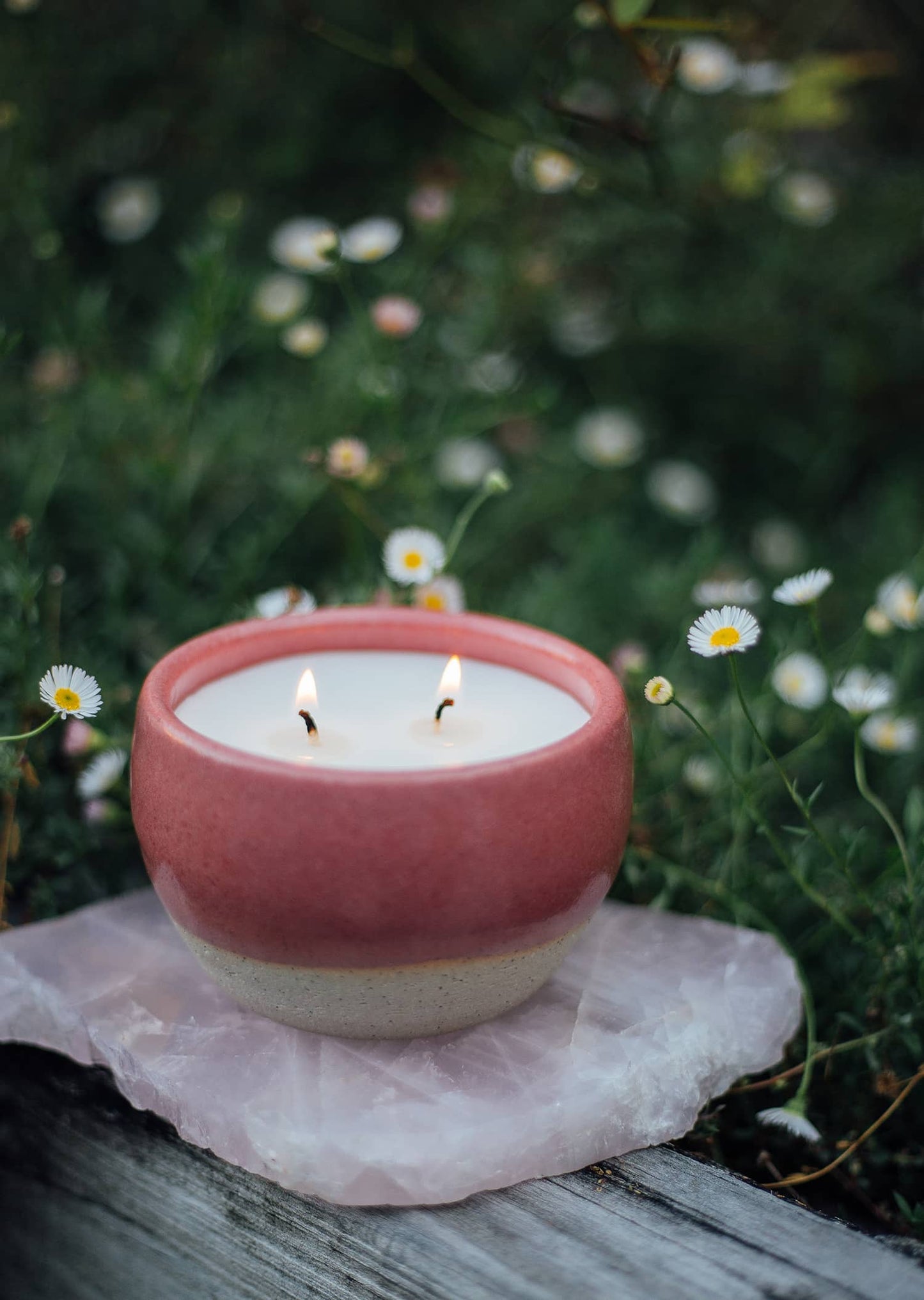 Àine & Co. Comfort Candle Cup in Bácáil (Fire). A reusable ceramic candle cup featuring a deep pink colour. Filled with a candle with two wicks.