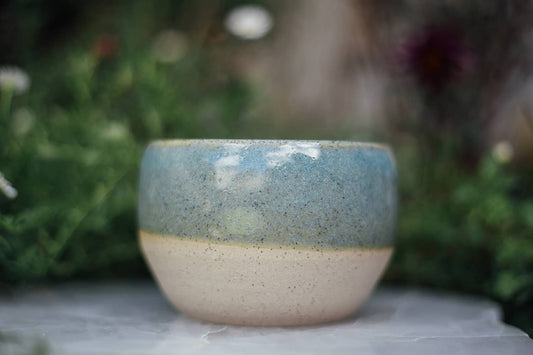 Àine & Co. Comfort Cup in Murúch (Mermaid). A reusable ceramic candle cup featuring a light teal colour.
