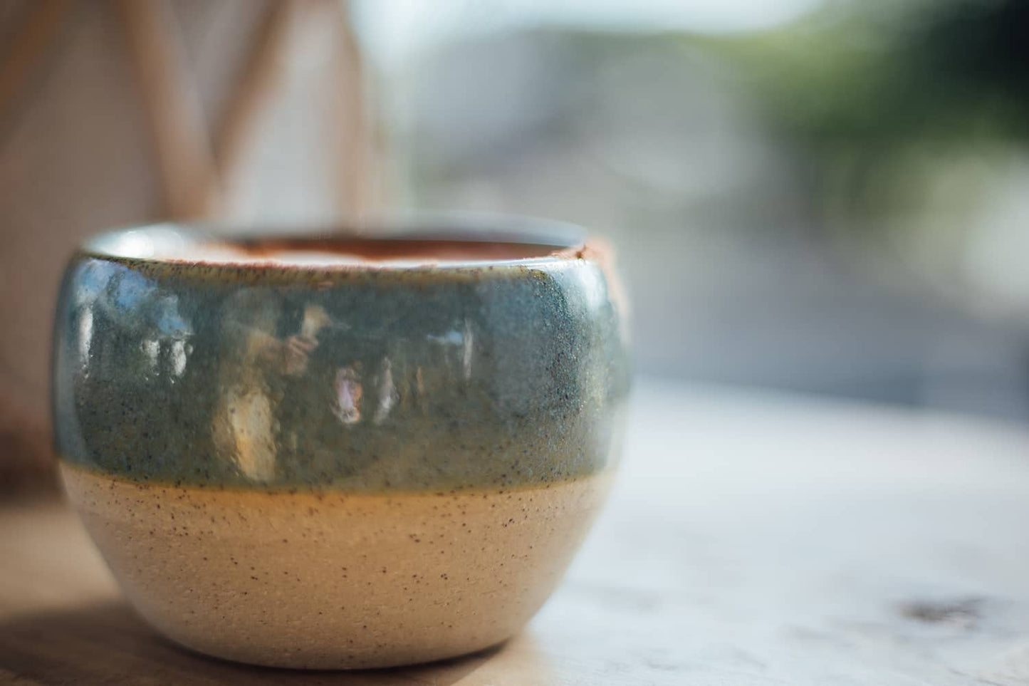 Àine & Co. Comfort Cup in Murúch (Mermaid). A reusable ceramic candle cup featuring a light teal colour.