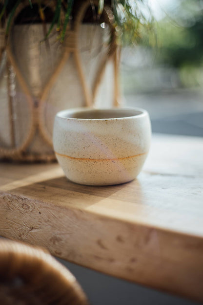Àine & Co. Comfort Cup in Gealghrá (Tender Pure Love). A reusable ceramic candle cup featuring a speckled white colour.