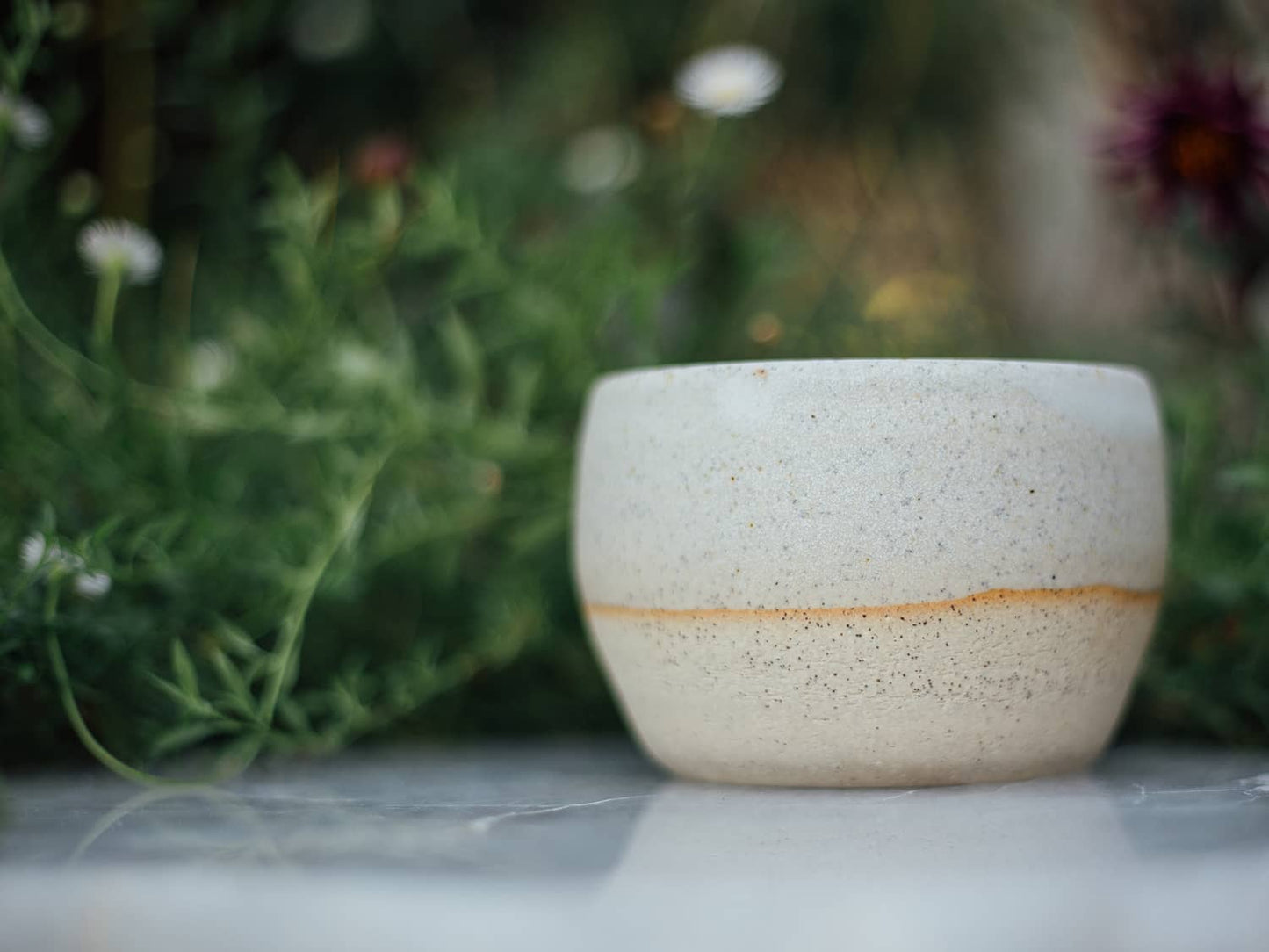 Àine & Co. Comfort Cup in Gealghrá (Tender Pure Love). A reusable ceramic candle cup featuring a speckled white colour.