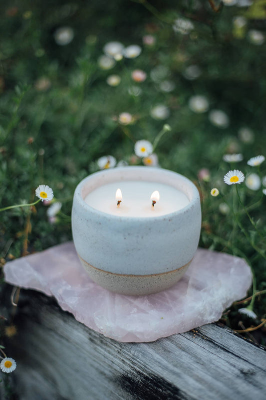 Àine & Co. Comfort Cup in Gealghrá (Tender Pure Love). A reusable ceramic candle cup featuring a speckled white colour. Filled with a candle with two wicks.