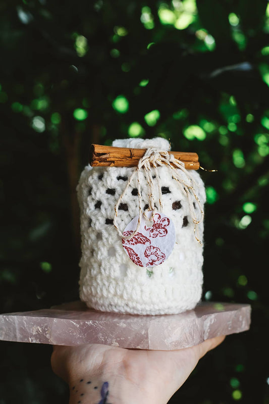 Àine & Co hand crotchet gift sack in white, finished with Àine & Co. hand stamped seed paper gift tag in red.