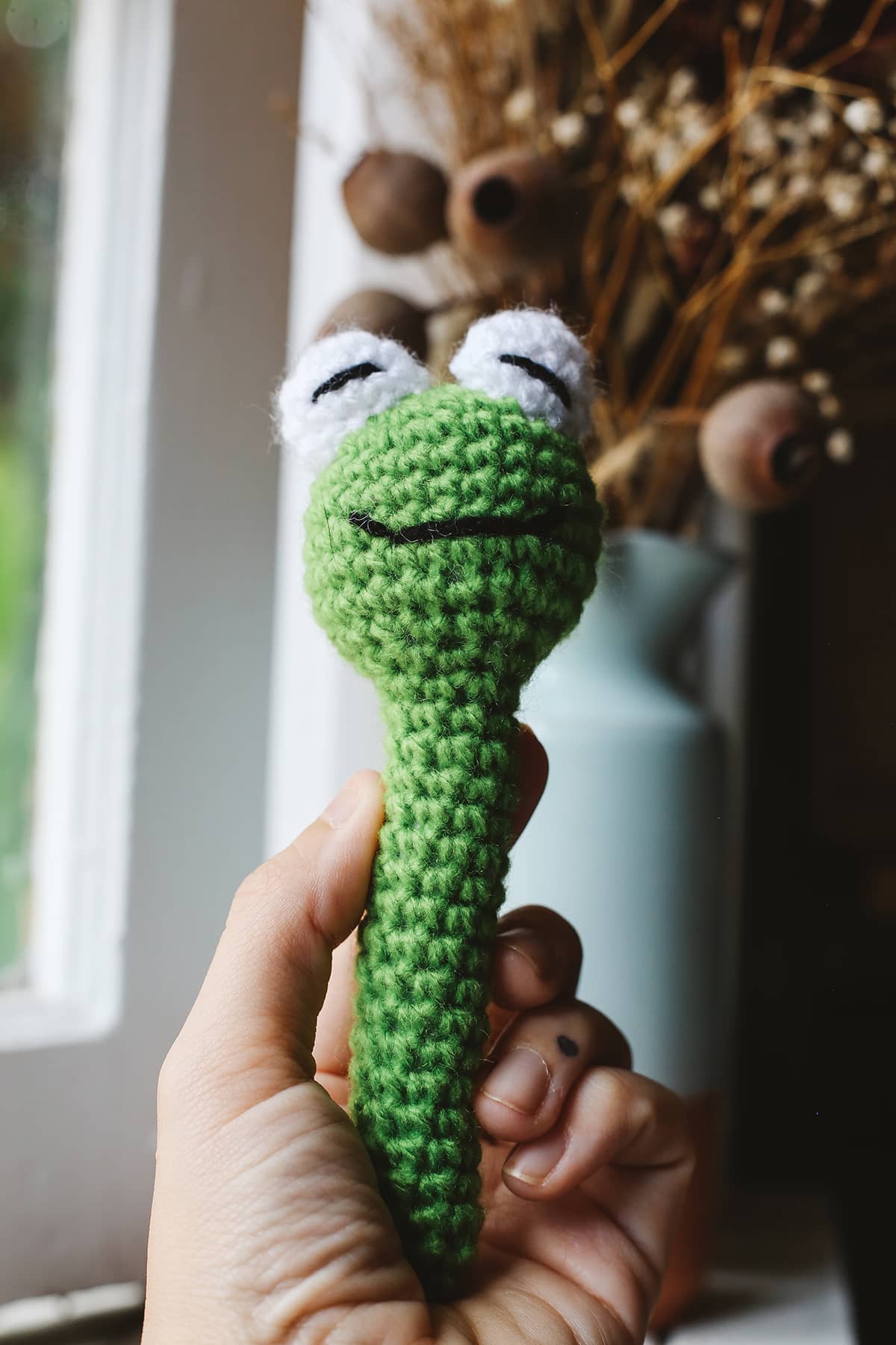 Àine & Co. Crochet Baby Rattle in "Frog", featuring green frog design