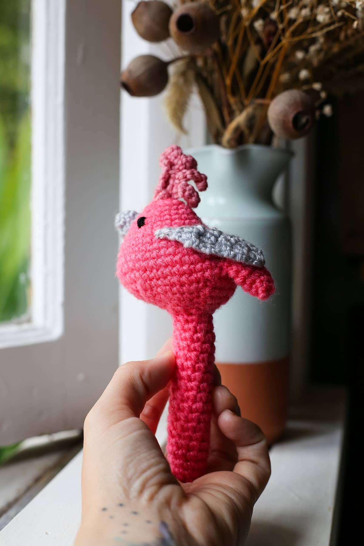 Àine & Co. Crochet Baby Rattle in "Pink Bird", featuring pink bird design
