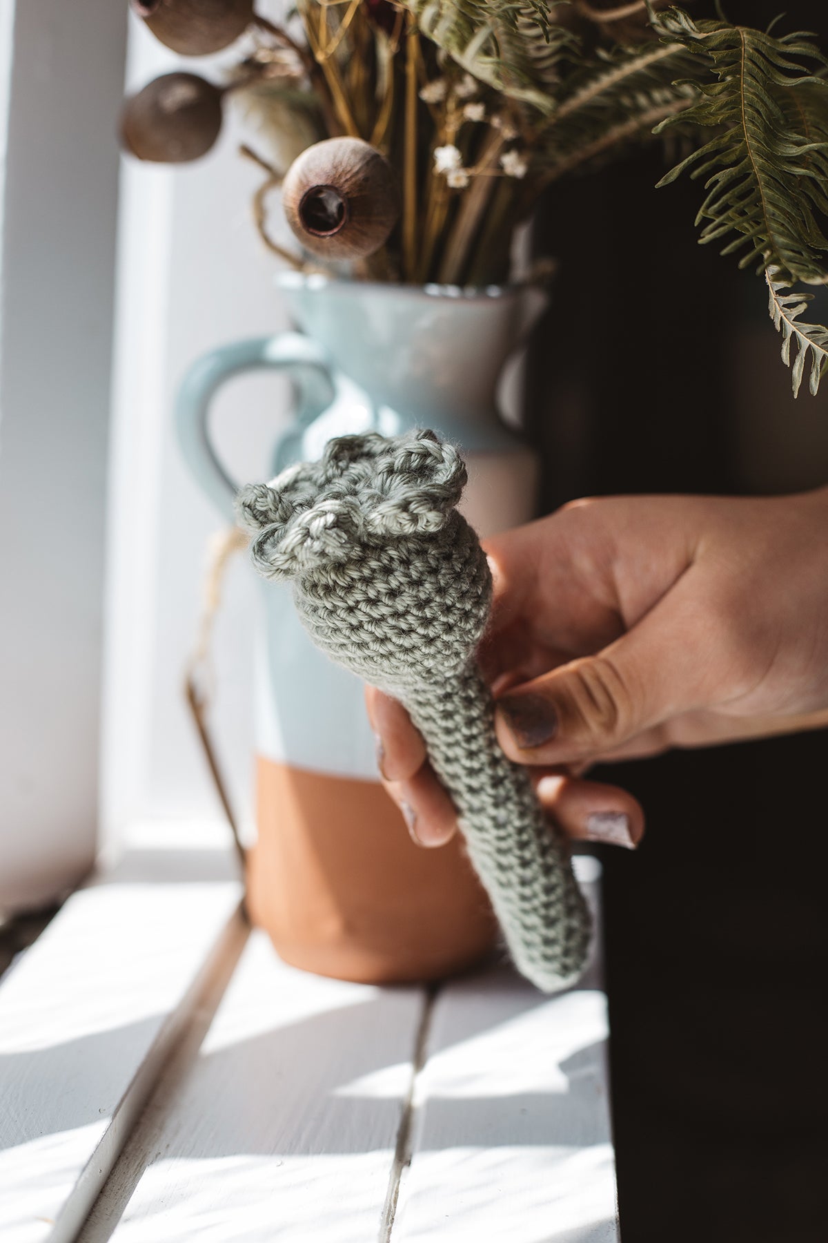 Àine & Co. Crochet Baby Rattle in "Clover", featuring sage clover design
