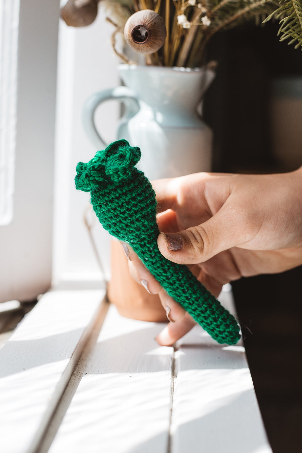 Àine & Co. Crochet Baby Rattle in "Clover", featuring dark green clover design