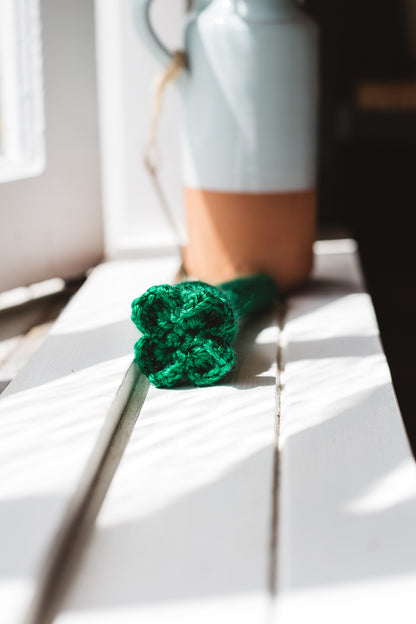 Àine & Co. Crochet Baby Rattle in "Clover", featuring dark green clover design