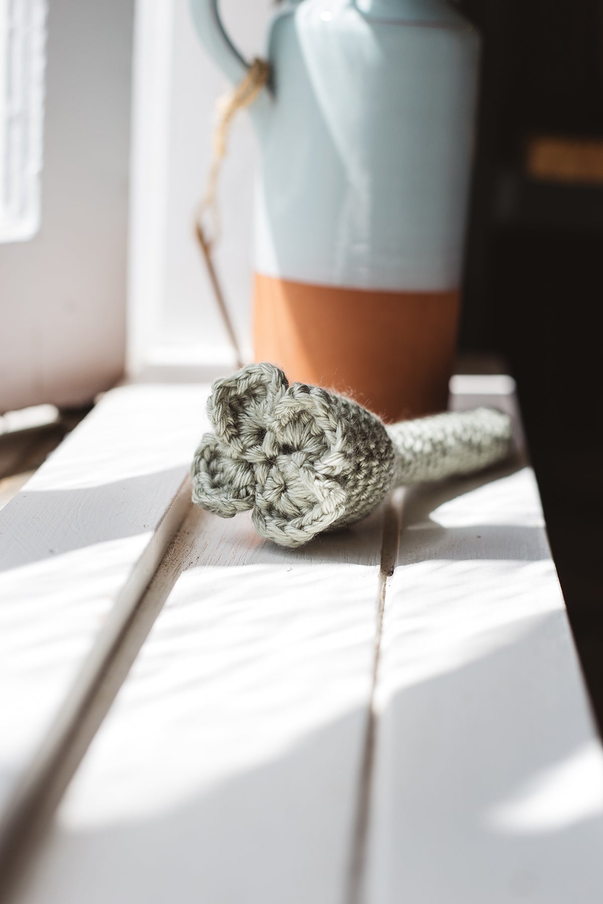 Àine & Co. Crochet Baby Rattle in "Clover", featuring sage clover design