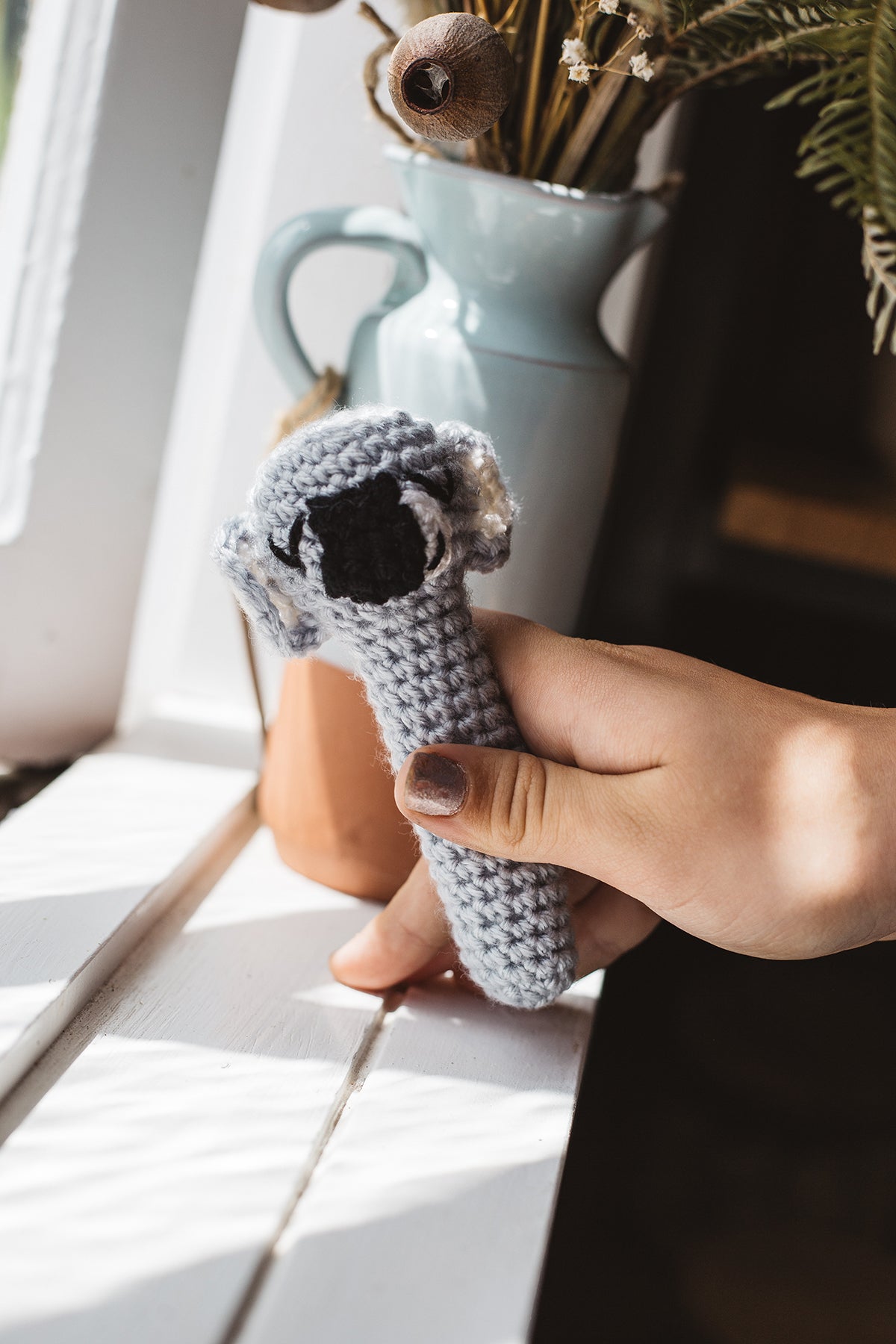Àine & Co. Crochet Baby Rattle in "Koala", featuring grey koala design