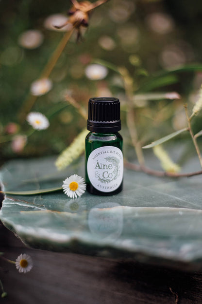 Àine & Co. Essential Oil Blend in the scent Australia in a small green dropper bottle with a black cap