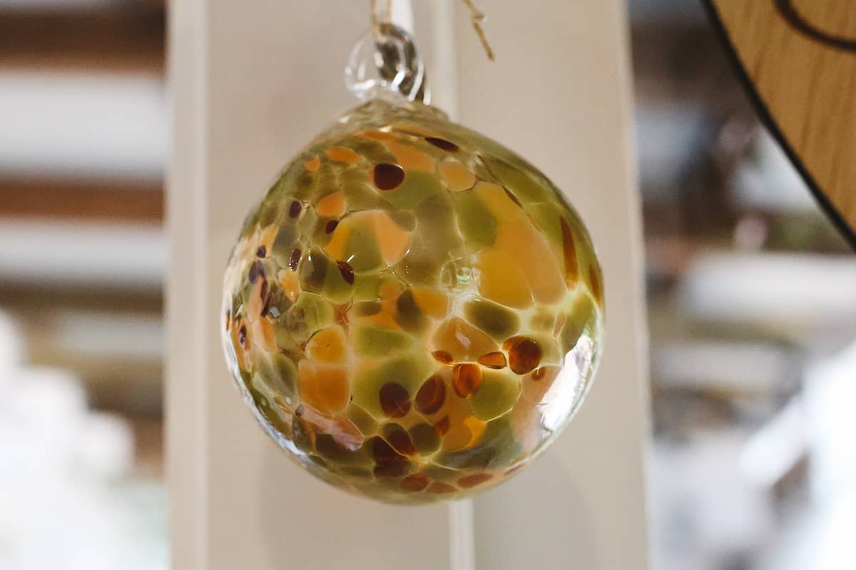 Àine & Co. Faerie Glass Bauble in style "B", featuring green, brown and orange glass design