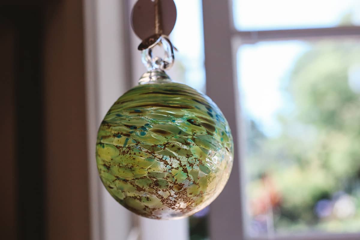 Àine & Co. Faerie Glass Bauble in style "D", featuring green and brown glass design