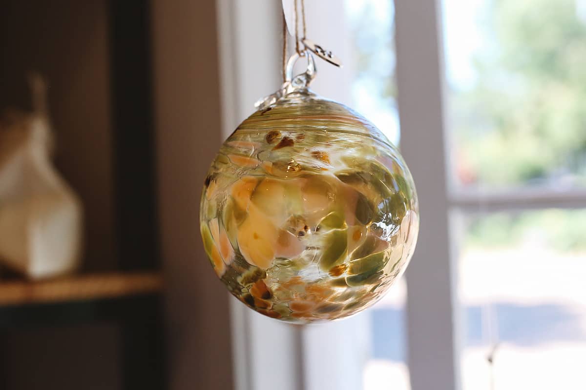 Àine & Co. Faerie Glass Bauble in style "E", featuring green and orange glass design