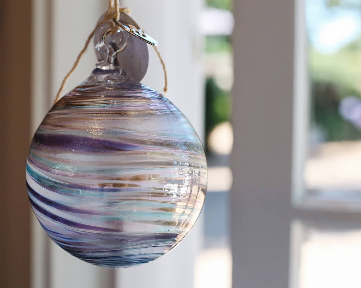 Àine & Co. Faerie Glass Bauble in style "F", featuring cool-toned purple, turquoise and gold glass swirl design
