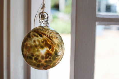 Àine & Co. Faerie Glass Bauble in style "G", featuring green and orange glass design