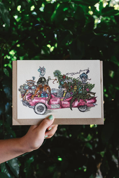 Gisela Greeting Card in "Pink Christmas" featuring an intricate illustration ofanimals in a pink convertible car with a Christmas tree in the back