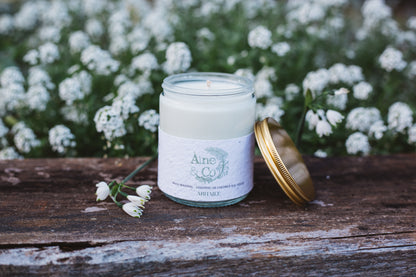 Áine & Co. glass candle jar in Abhaile packaged in a clear jar and gold lid