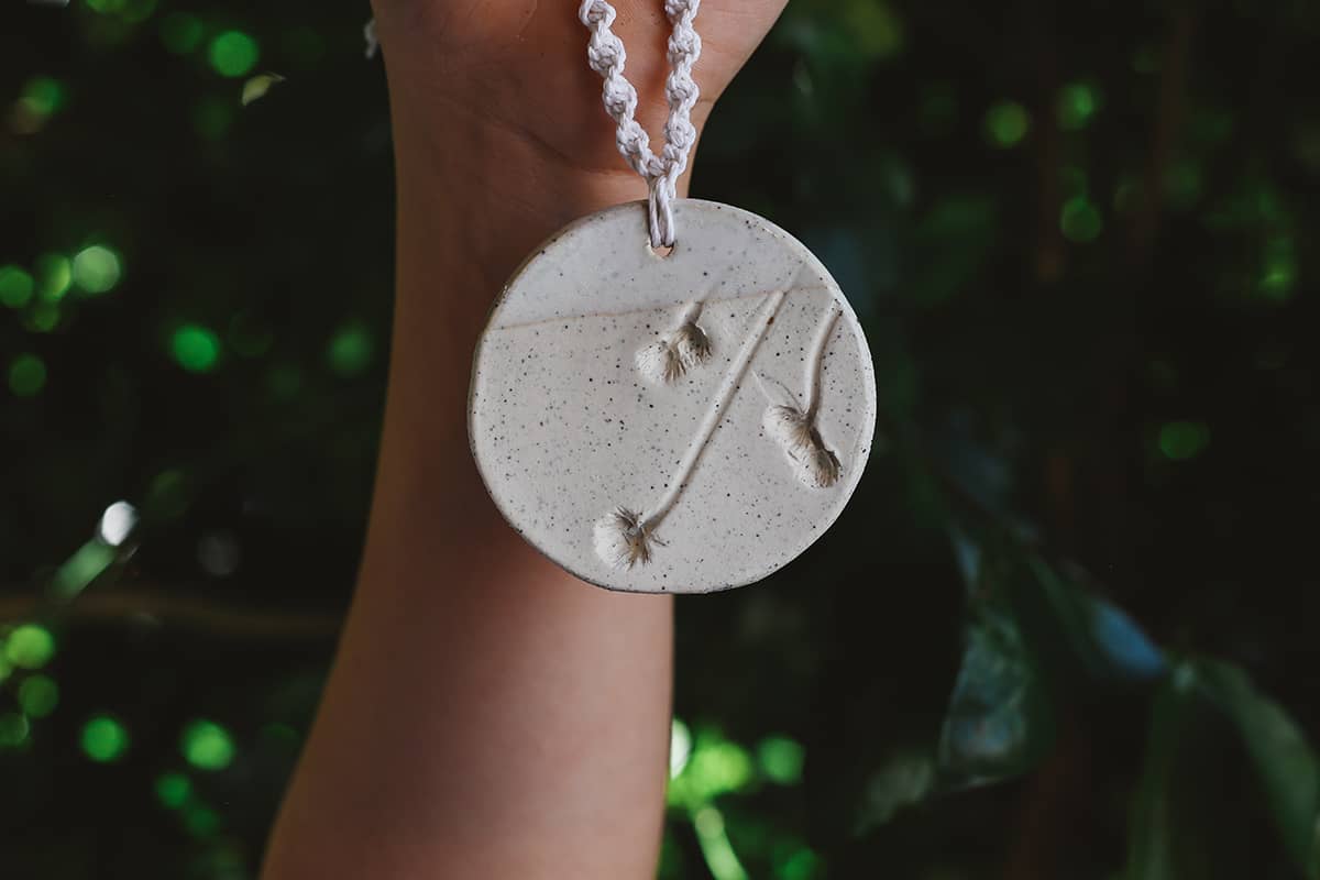 Àine & Co. Handmade Ceramic Car Diffusers in botanical disk style featuring woven string