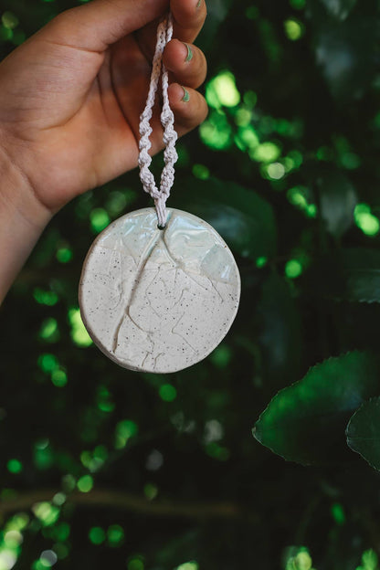 Àine & Co. Handmade Ceramic Car Diffusers in botanical disk style featuring woven string